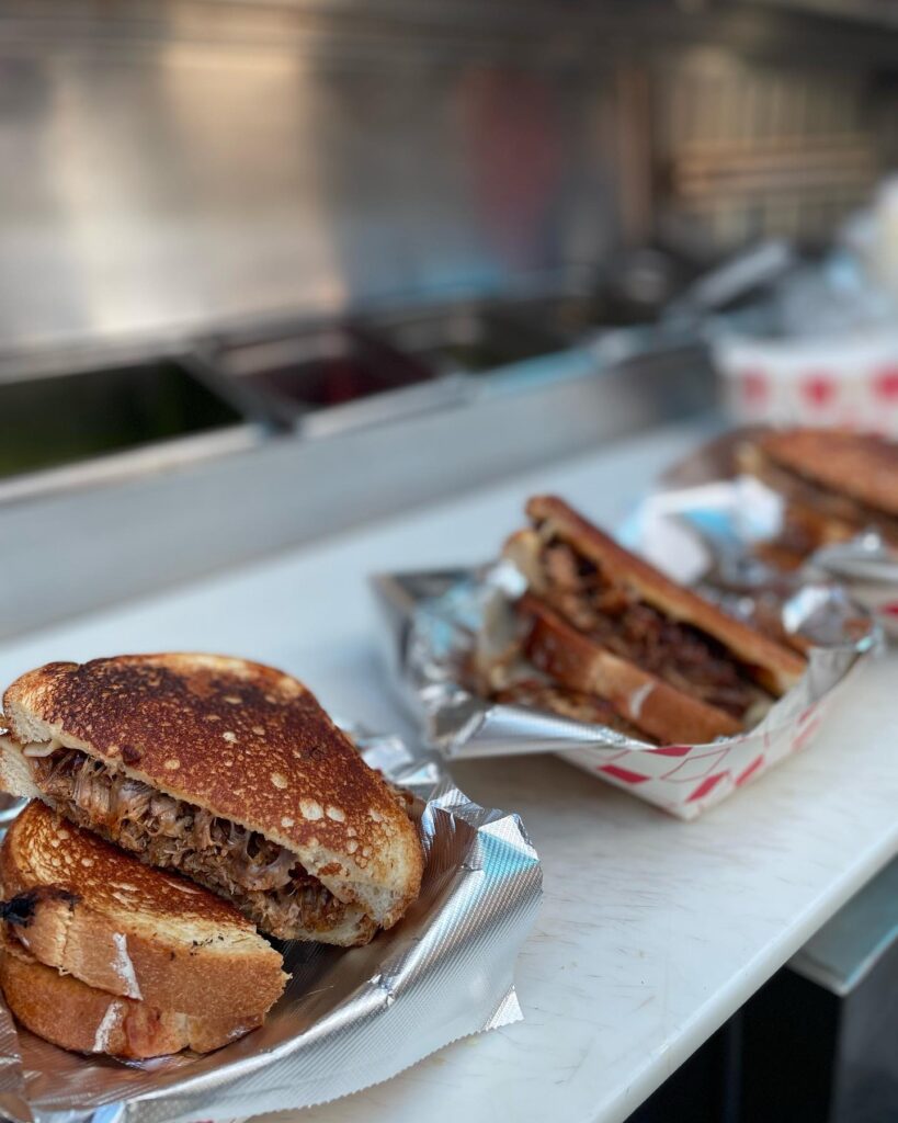 burgers and sandwiches lined up on counter